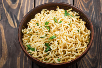 bowl of traditional Chinese noodles on wooden background, top view