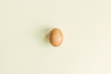 Chicken egg on a yellow pastel background, new trend in photography