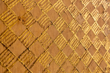 Detail on wall with squares and gold colored lines