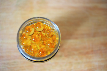 Yellow capsules in a jar