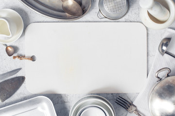 White kitchen background - cutting board decorated with cookware
