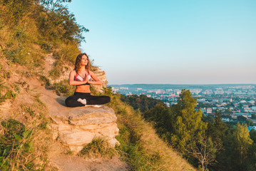 young pretty woman on sunrise. yoga exercise