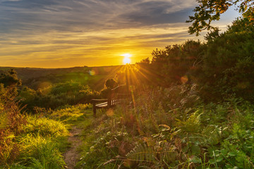 A bench in the sunset, seen in Ilfracombe, North Devon, England, UK