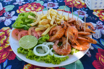 Shrimp dish served at a beach bar on Coroa do Aviao islet, popular destination on the north coast of Pernambuco state (Igarassu, Brazil)