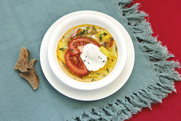 Cabbage soup with fresh cabbage and sour cream in a white plate. Dietary vegetable soup