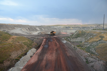 Giant size coal mining vehicle driving inside a vast open pit coal mine in the Powder River Basin, Wyoming, USA.