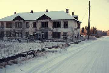 Old destroyed non-residential building on the background of the forest