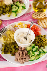 Cobb style salad with diced vegetables and canned cod liver