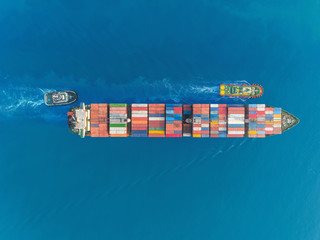 Aerial top view container ship at sea port and working crane bridge for loading container, logistic...