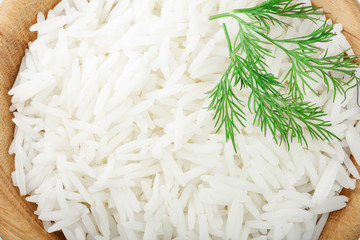 rice in a wooden bowl as a background closeup. Top view. Flat lay