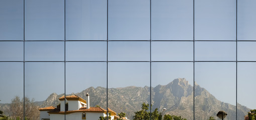 reflections in the windows of a modern building