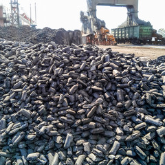 Piles of raw steel briquettes. Heap of coal anthracite in the po