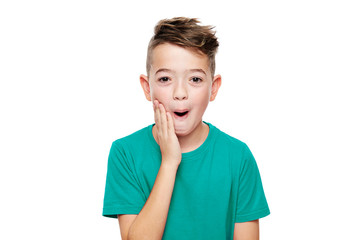 Adorable young boy in shock, isolated over white background. Shocked child looking at camera in disbelief. Shock, amazement, surprise concept.