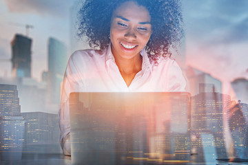 Cheerful African American woman with laptop