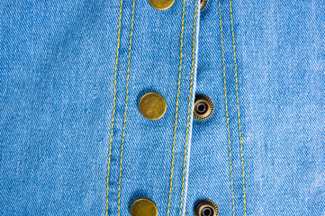 Blue washed faded jeans texture with seams, clasps, buttons and rivets