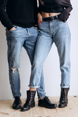 Two hipster models: a man and a woman in a blank black t-shirt, jeans and posing. in a black hat, cap, love, kisses