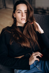 Beautiful girl in a black cap, black golf, blue jeans! Natural light, smart casua, street casual