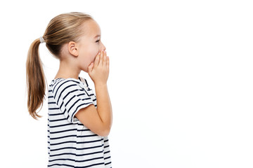 Cute little girl in stripped T-shirt shouting. Speech therapy concept over white background.