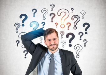 Confused businessman, question marks
