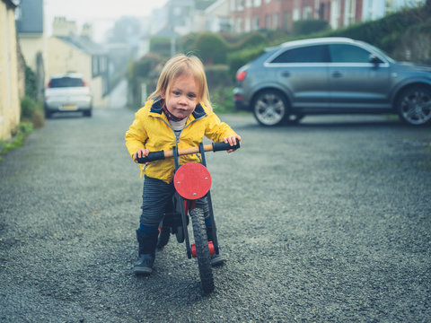 Little toddler riding a balance bike