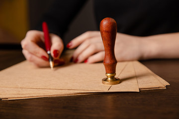 Notary signing a contract with fountain pen in dark room concept. pen business man law attorney...