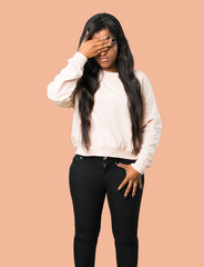 Young afro american woman covering eyes by hands. Do not want to see something on isolated brown background