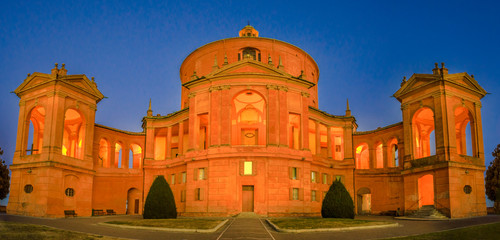 Panorama of courtyard Sanctuary of Madonna di San Luca illuminated at blue hour. Facade of Basilica church of San Luca in Bologna, Emilia-Romagna, Italy. Famous landmark cityscape. © bennymarty