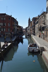 Narrow And Beautiful Channels With Atos Buildings To The Sides In Venice. Travel, holidays, architecture. March 28, 2015. Venice, Veneto region, Italy. - obrazy, fototapety, plakaty