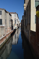 Fototapeta na wymiar Narrow And Beautiful Channels With Atos Buildings To The Sides In Venice. Travel, holidays, architecture. March 28, 2015. Venice, Veneto region, Italy.