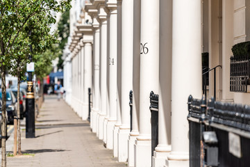 London neighborhood district of Pimlico with housing buildings and numbers on columns in old vintage historic traditional style flats - obrazy, fototapety, plakaty