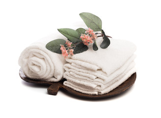 Stack of clean white soft towels with flower on white background - Image.