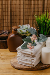 Spa still life with aromatic candles, flower and towel. - Imag