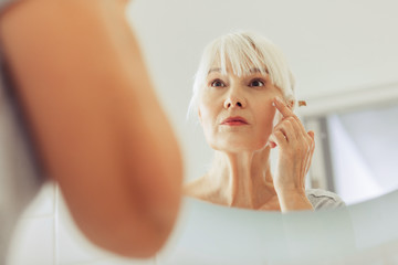 Mirror reflection of a nice aged woman