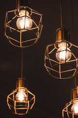 Fototapeta na wymiar Ceiling chandelier with hanging bulb lamps