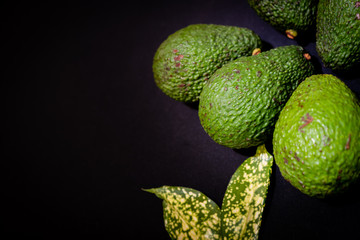 food background with fresh organic avocado on black table, top view, copy space