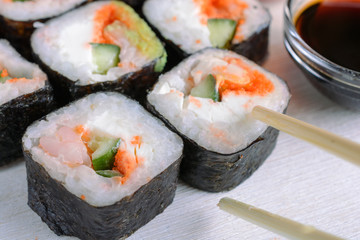 Sushi rolls made from rice, shrimp, flying fish roe and nori, cooked in a fast delivery cafe