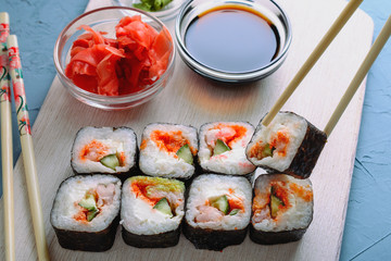 Sushi rolls made from rice, shrimp, flying fish roe and nori, cooked in a fast delivery cafe