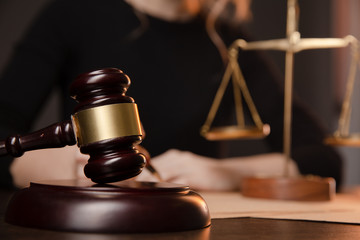 Male lawyer working with contract papers and wooden gavel on tabel in courtroom. justice and law...