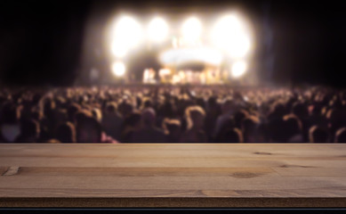 Empty table top for product display montage. Crowd at concert, summer music festival blurred in the...