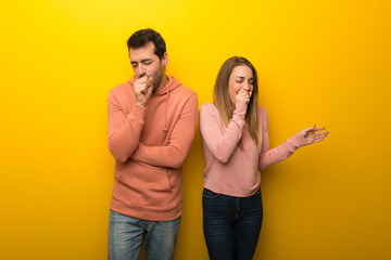 Fototapeta premium Group of two people on yellow background is suffering with cough and feeling bad