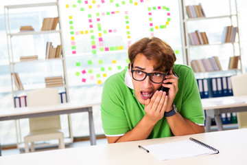 Student struggling at the exam in classroom