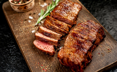 Beef steak on the cutting board with spices