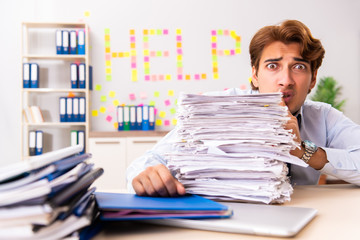 Fototapeta premium Young employee suffering from excessive work 