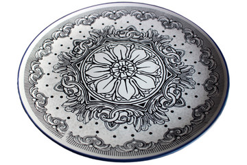 Traditional greek flat white plate with black patterns and blue border isolated
