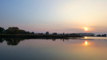 Fototapeta na wymiar Warm evening on the quiet lake