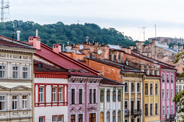 Fototapeta na wymiar Historic Lviv, Ukraine cityscape with colorful architecture buildings in old town market square in sunset evening night multicolor houses