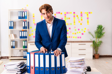 Young employee suffering from excessive work  