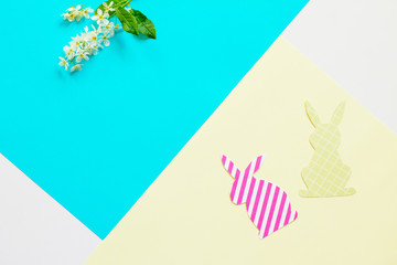 Easter bunny paper and spring flowers. Minimal easter concept. Top view flat lay background. Copy space.