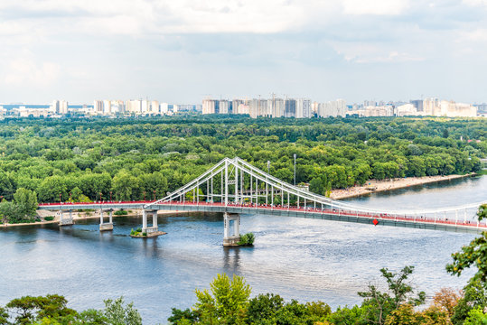 Kyiv, Ukraine overlook of city and river bridge in Kiev summer with view of residential neighborhood Darnytsia suburbs Soviet and modern buildings