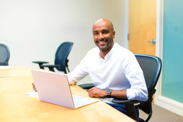 Young afro american businessman in the office with his laptop